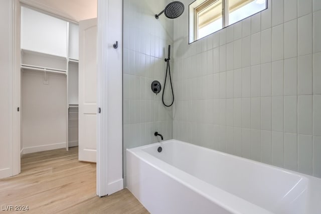 bathroom featuring hardwood / wood-style flooring and tiled shower / bath