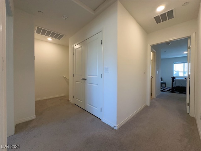 corridor featuring light colored carpet