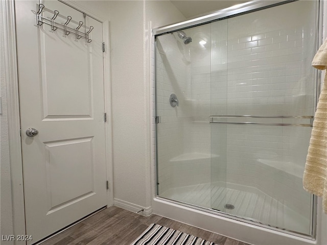 bathroom featuring walk in shower and hardwood / wood-style flooring