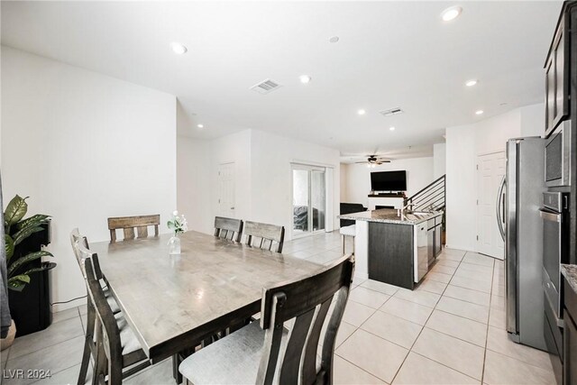 dining space featuring ceiling fan and light tile patterned floors