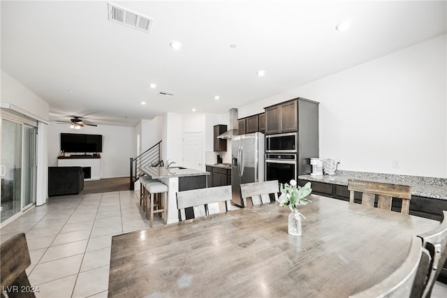 dining area with ceiling fan and light tile patterned floors