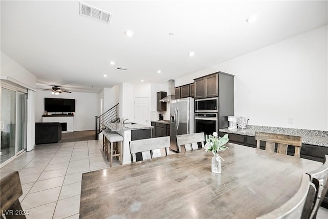 dining room with ceiling fan and light tile patterned floors