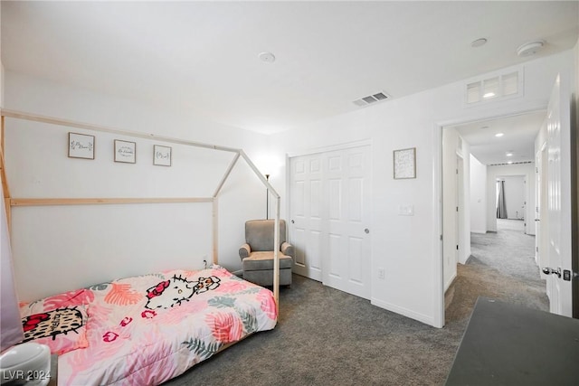 bedroom featuring dark carpet and a closet