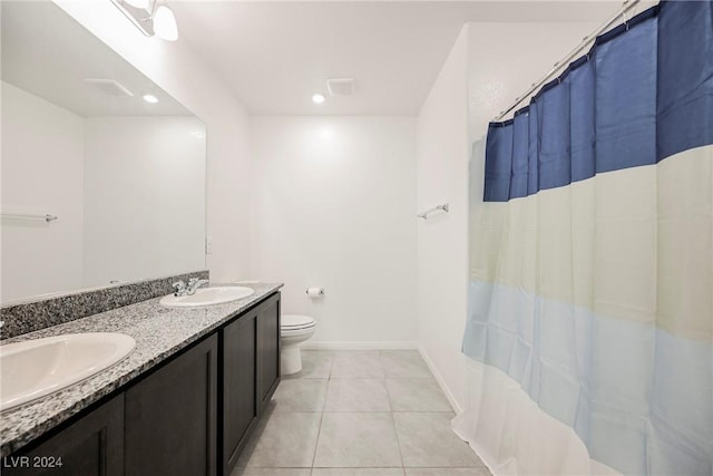 bathroom with tile patterned flooring, curtained shower, vanity, and toilet