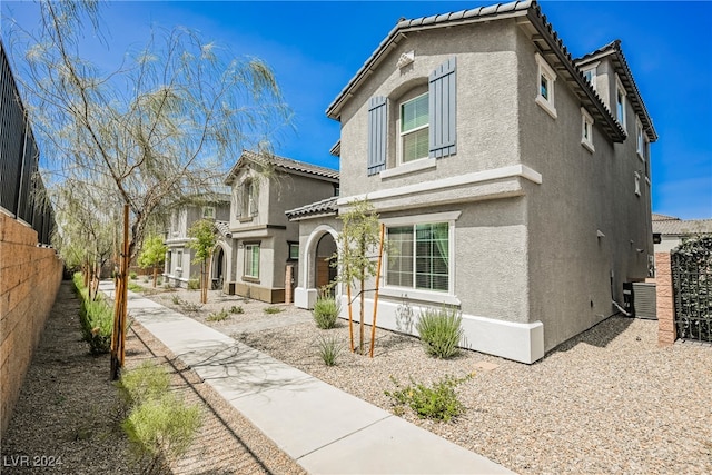 mediterranean / spanish-style house with central AC unit