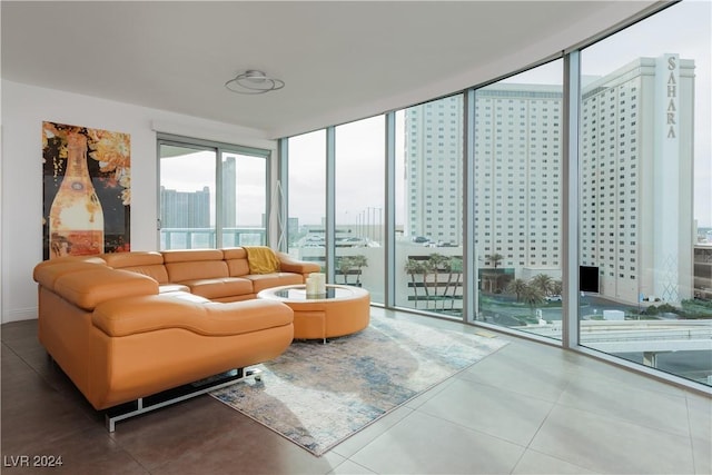 living room with floor to ceiling windows and tile patterned floors