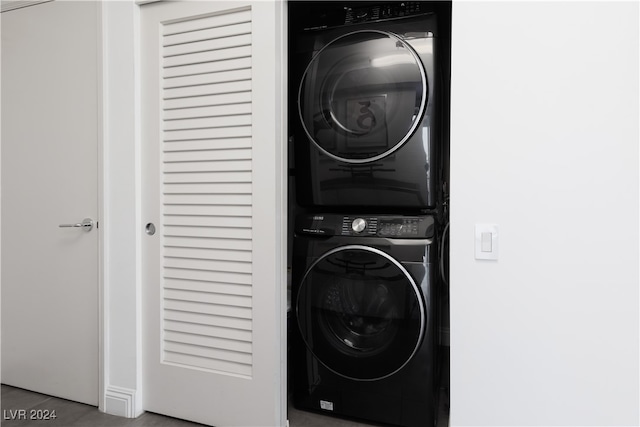 laundry room with stacked washer / drying machine