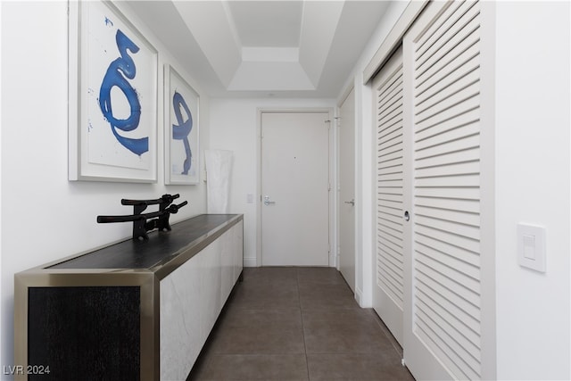 hallway with dark tile patterned flooring