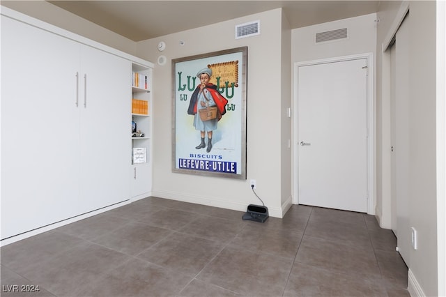 interior space with dark tile patterned floors