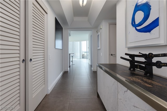 hall with dark tile patterned flooring