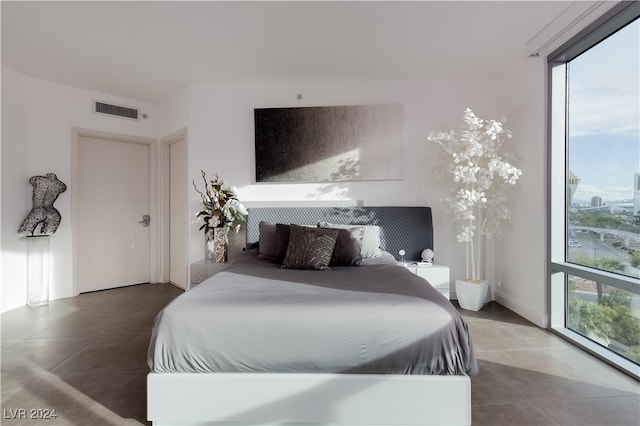 tiled bedroom with multiple windows