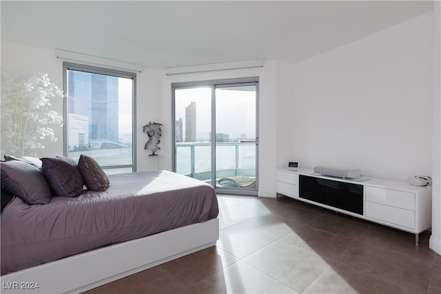 bedroom with tile patterned floors and access to outside