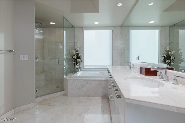 bathroom featuring tile patterned floors, vanity, and separate shower and tub