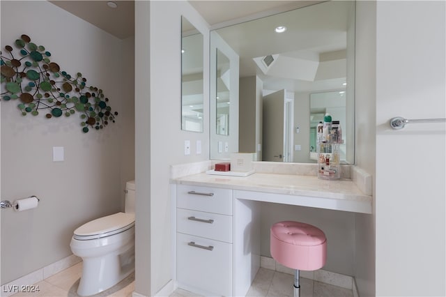 bathroom with vanity, toilet, and tile patterned flooring