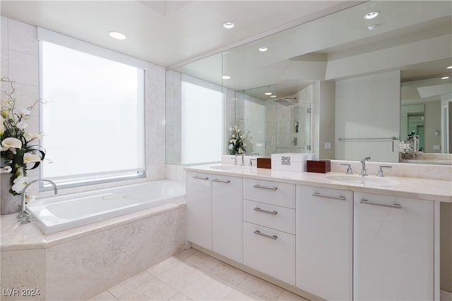 bathroom featuring independent shower and bath, vanity, and tile patterned floors