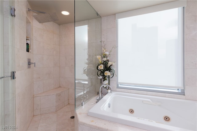 bathroom featuring separate shower and tub