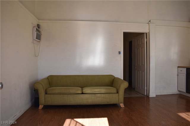 living room with dark hardwood / wood-style floors, an AC wall unit, and crown molding