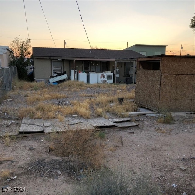 view of back house at dusk