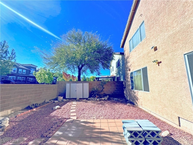 view of patio featuring a shed