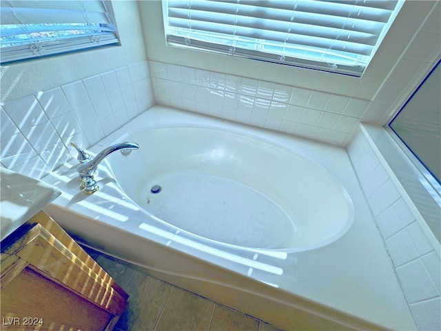 bathroom with tile patterned floors and a bathtub