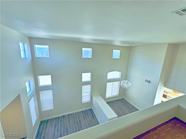 details with hardwood / wood-style floors and a notable chandelier