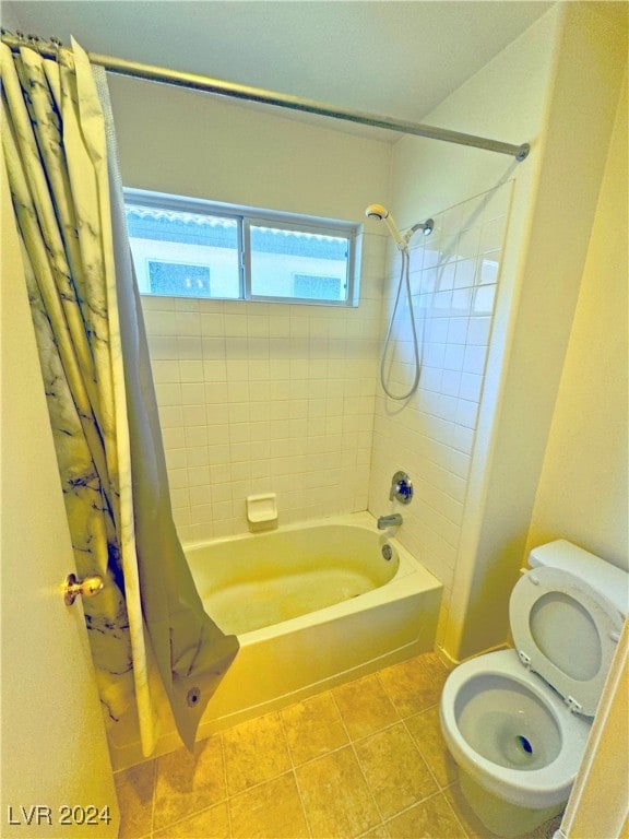 bathroom featuring tile patterned flooring, shower / bath combo, and toilet