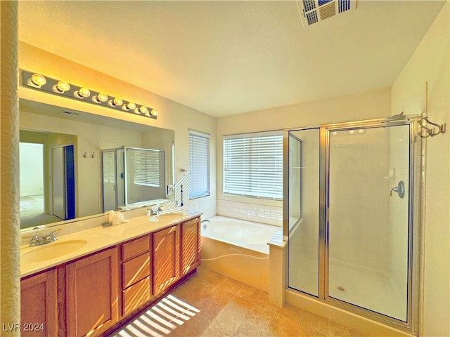 bathroom with vanity and separate shower and tub