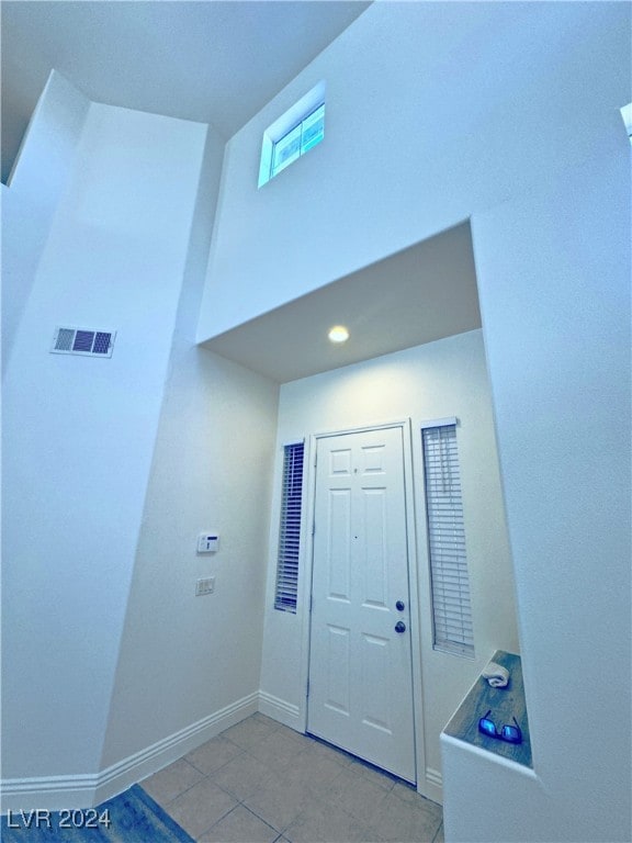 entryway with light tile patterned floors