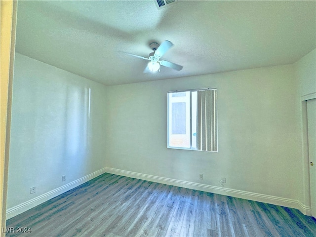 unfurnished room featuring hardwood / wood-style floors, ceiling fan, and a textured ceiling