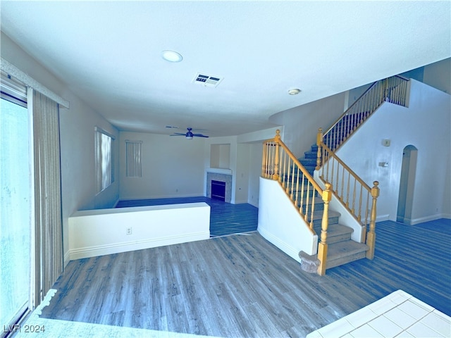 interior space with ceiling fan and wood-type flooring