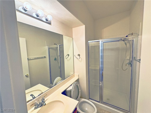 bathroom with vanity, toilet, and a shower with door