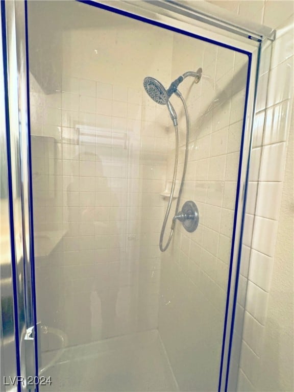 bathroom with a shower with shower door