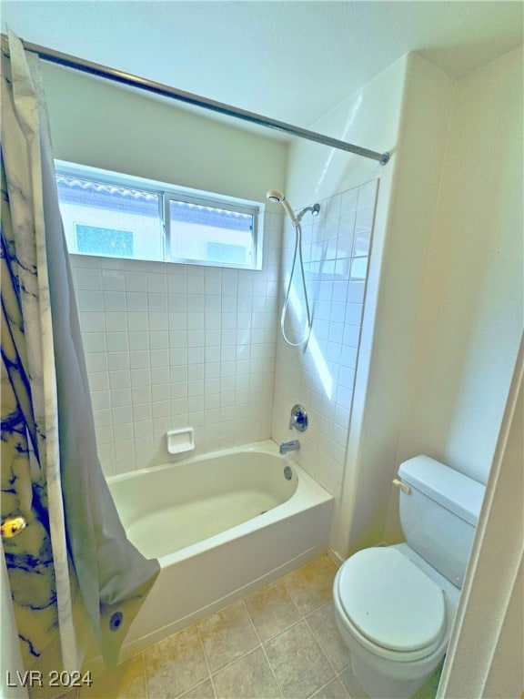 bathroom with tile patterned flooring, shower / tub combo with curtain, and toilet