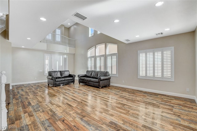 living room featuring hardwood / wood-style flooring and a high ceiling