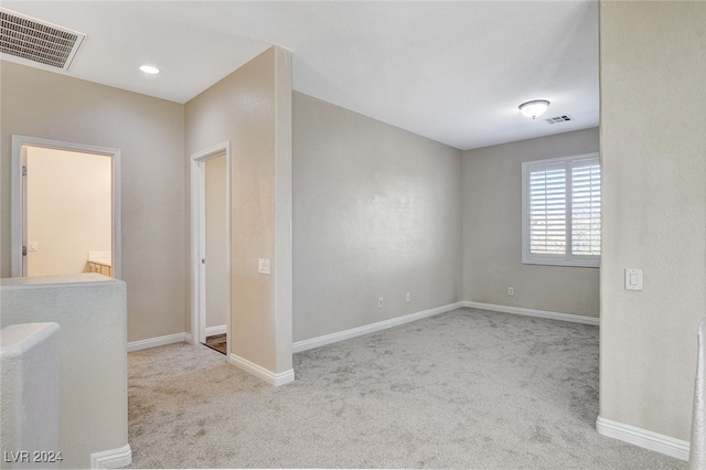 empty room featuring light carpet