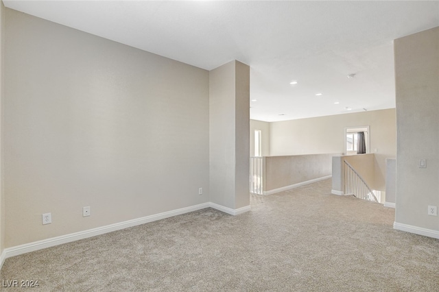 spare room featuring light colored carpet