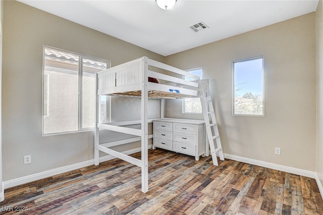 unfurnished bedroom featuring dark wood-type flooring