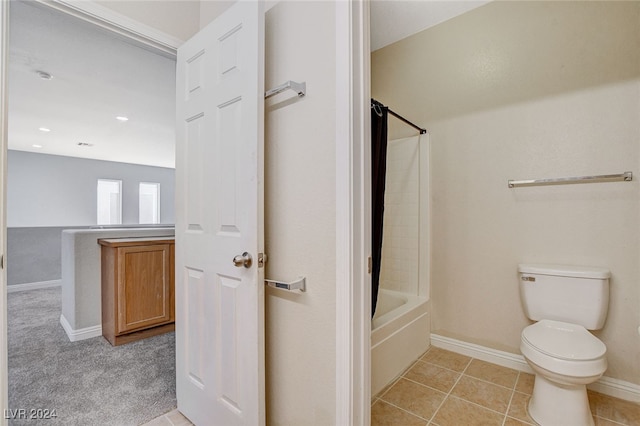 bathroom with toilet, washtub / shower combination, and tile patterned floors