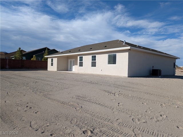 rear view of property featuring central AC