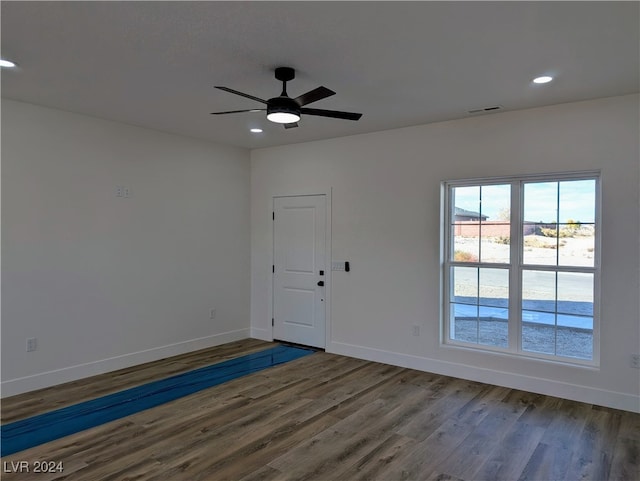 unfurnished room featuring ceiling fan and dark hardwood / wood-style floors