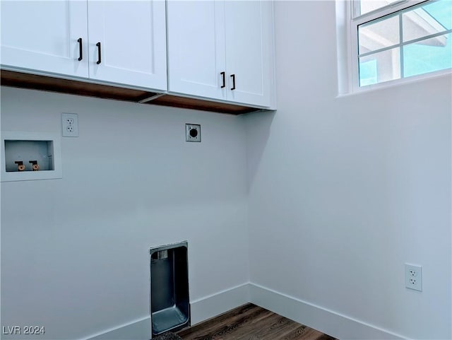 laundry area featuring dark hardwood / wood-style floors, hookup for an electric dryer, hookup for a washing machine, and cabinets