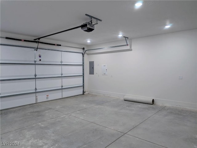 garage with a garage door opener and electric panel