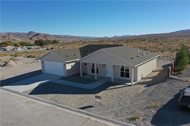 view of front of property with a mountain view and a garage