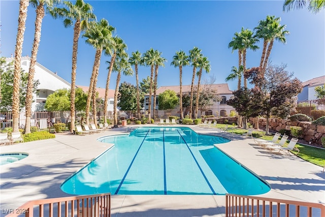 view of pool with a hot tub and a patio