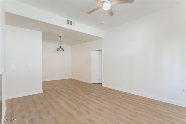 spare room with light hardwood / wood-style floors and ceiling fan