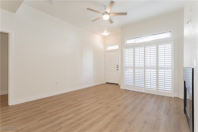 unfurnished living room with light wood-type flooring and ceiling fan