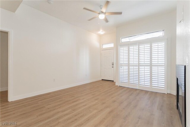 700 Carnegie St Unit 2312, Henderson, NV 89052 - unfurnished living room with light wood-type flooring, ceiling fan, and baseboards