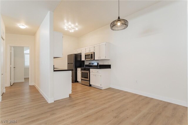 700 Carnegie St Unit 2312, Henderson, NV 89052 - kitchen with appliances with stainless steel finishes, dark countertops, baseboards, and light wood-style flooring