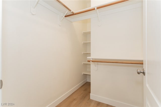 walk in closet with light wood-type flooring