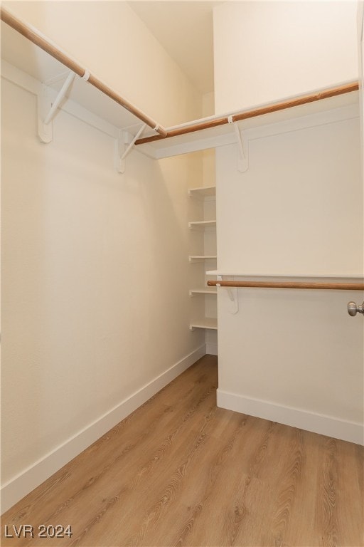 walk in closet featuring light hardwood / wood-style floors